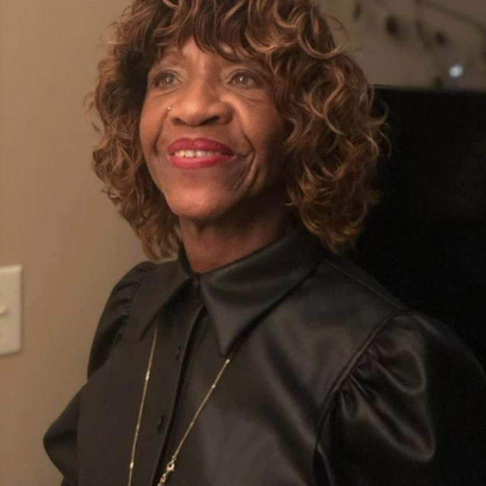 Image of Self-Esteem's Board member Joan Young Johnson, looking up and smiling.